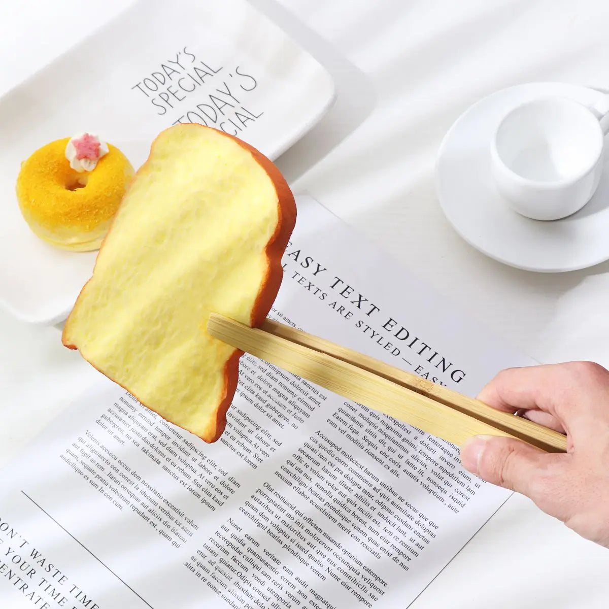 Ergonomic bamboo kitchen tongs gripping salad in bowl